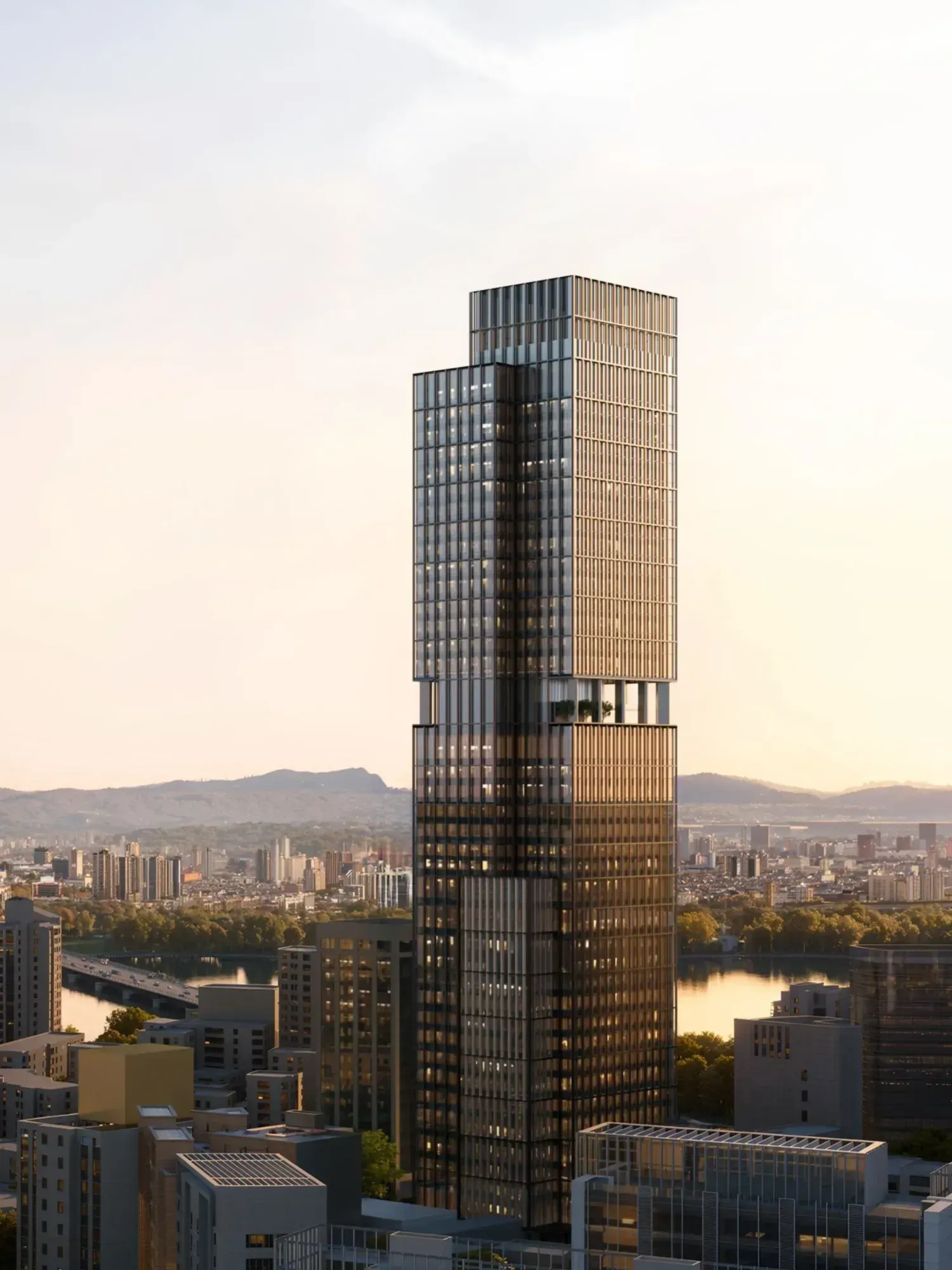 Render of a dark glass and bronze-finned tower rising above low-rise Seoul at sunset, with the Han River and a bridge behind it and mountains on the horizon.
