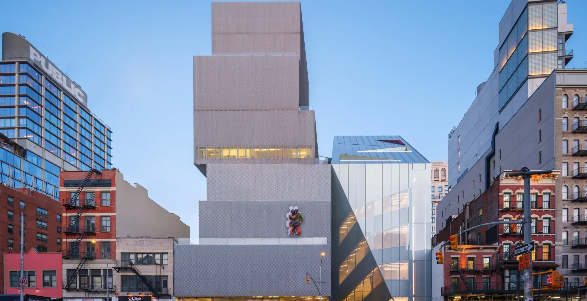 The New Museum on the Bowery, a stack of offset white boxes above the street, with pedestrians crossing in front