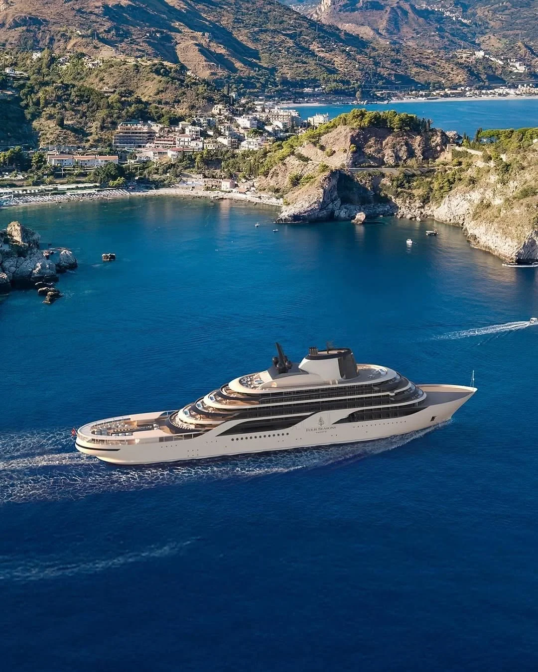Four Seasons I anchored in a cove beneath a wooded Mediterranean headland