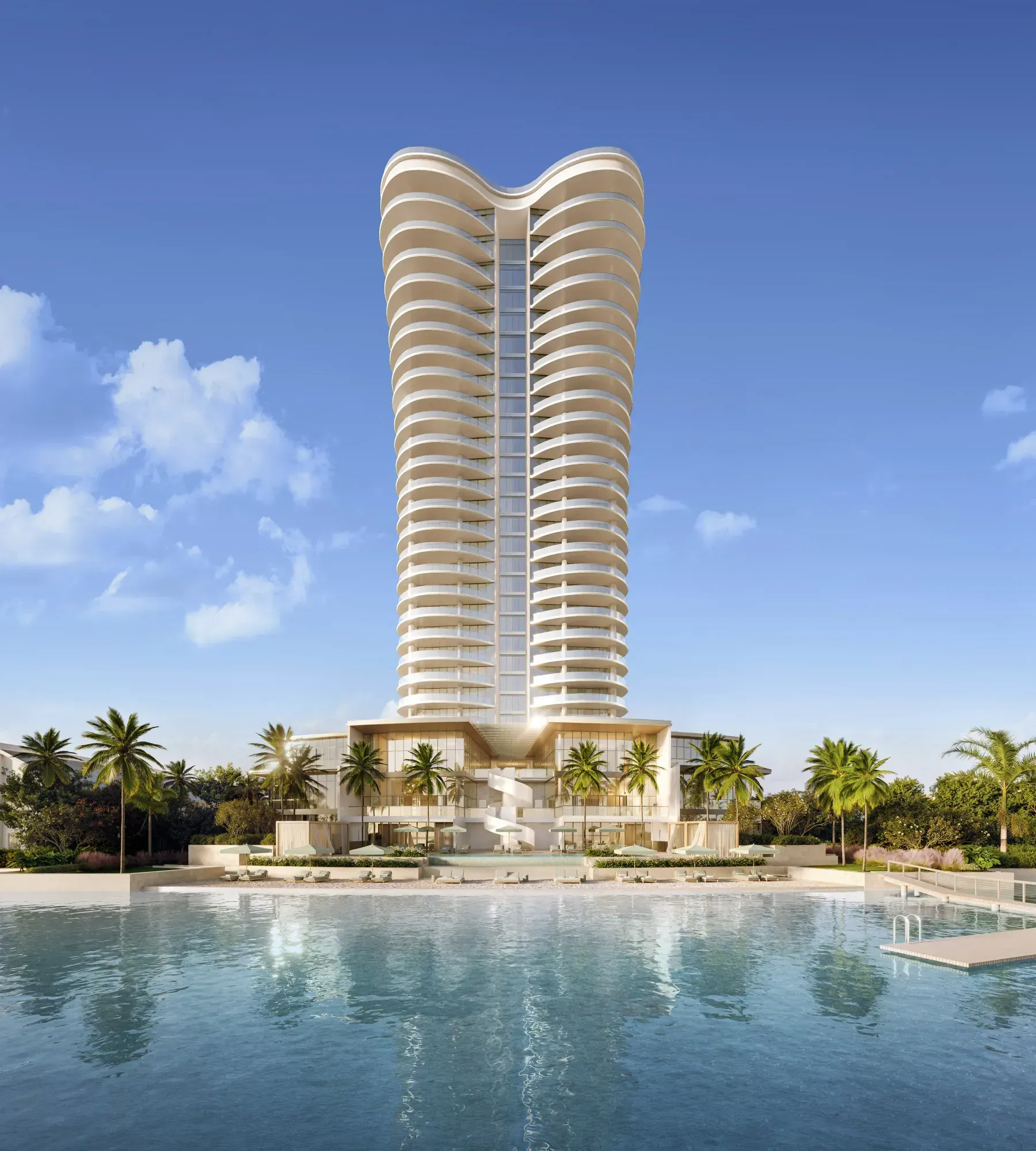 The 31-story tower seen across the Intracoastal Waterway, its stacked balcony plates tapering as they rise off a splayed podium