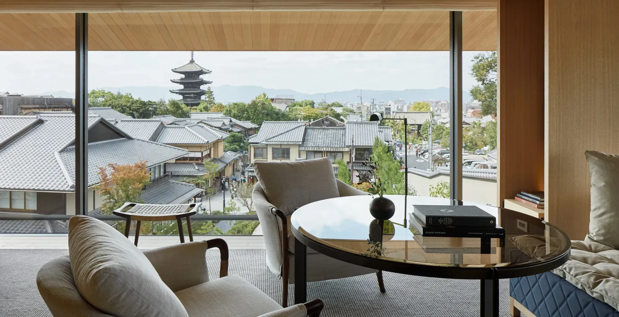 The Yasaka Pagoda framed in the window of the Ninenzaka House, above the tiled roofs of Higashiyama