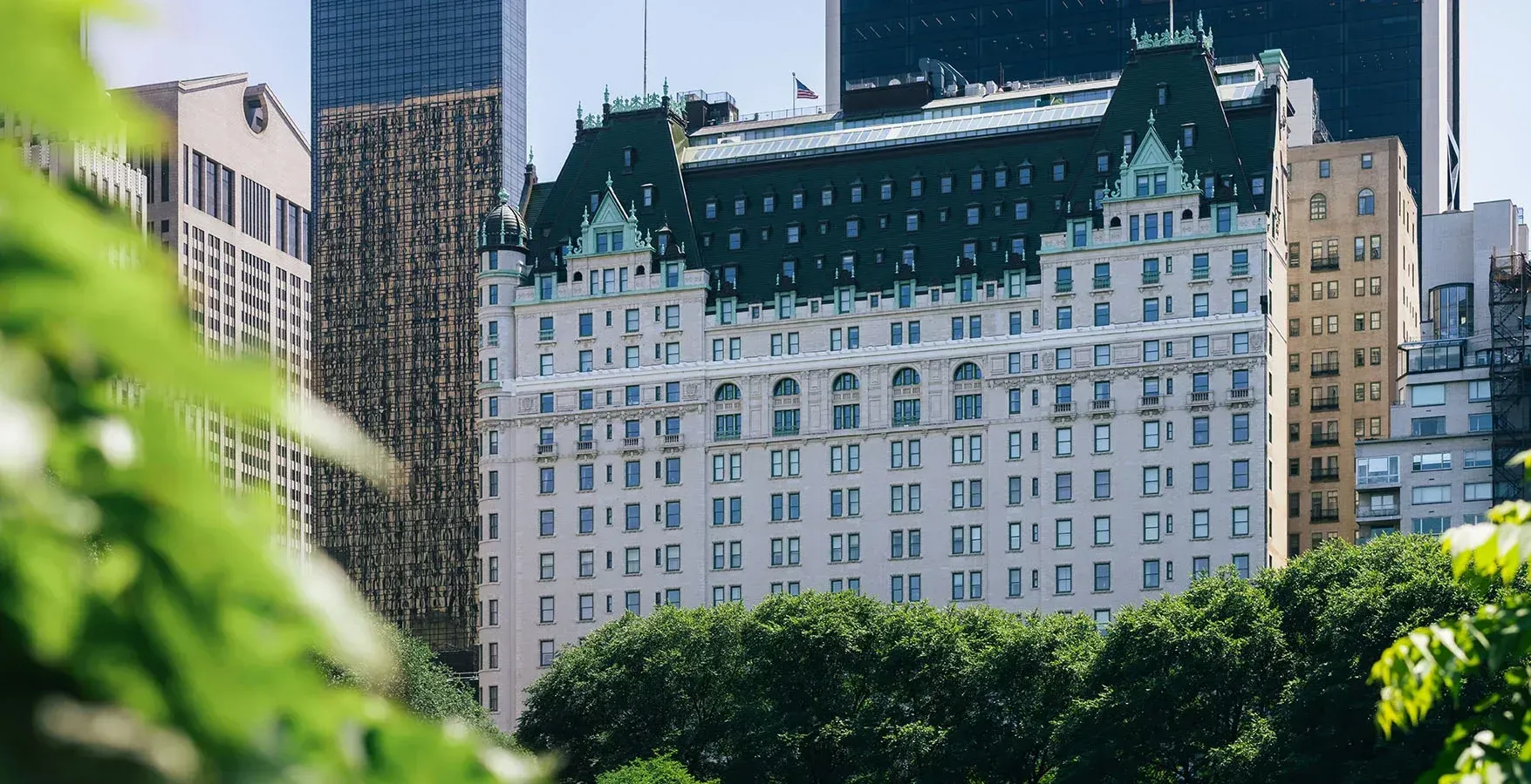 The Plaza's white facade and green mansard roof seen from Central Park